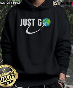 Solo traveler wearing 'Good Just Go' hoodie with globe and airplane design, perfect for travel addicts and adventure lovers.