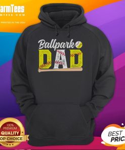 Happy dad in a baseball hoodie, celebrating as a proud baseball and softball dad of ballers at the ballpark.