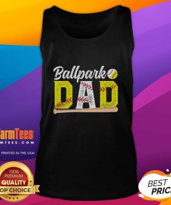 Happy dad wearing a tank top that says 'Dad of Ballers' at a baseball and softball game, celebrating with joy.