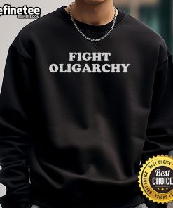 Activist wearing a 'Hot Fight Oligarchy' sweatshirt, standing in protest against corporate greed.