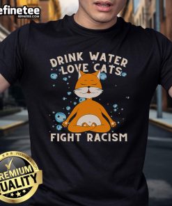 Cat mom wearing a 'Nice Drink Water Love Cats Fight Racism' T-shirt, showcasing love for cats and anti-racism message.