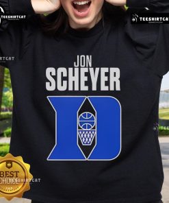 Jon Scheyer wearing a Duke Blue Devils Coach of the Year sweatshirt during a basketball game celebration.