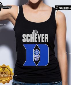 Alt Text: Jon Scheyer, Duke Blue Devils basketball coach of the year, wearing a stylish tank top at a game.