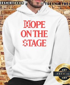Person wearing a Nice Hope On The Stage hoodie, showcasing stylish design and vibrant colors at a live event.