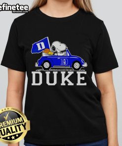 Snoopy and Woodstock driving in a car, featuring a Duke Blue Devils basketball ladies tee design.