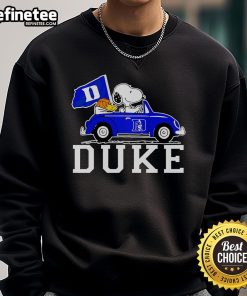 Alt Text: Snoopy and Woodstock driving in a Duke Blue Devils basketball sweatshirt, showcasing team spirit and fun.