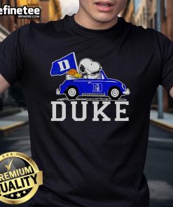 Alt Text: Snoopy and Woodstock driving a car on a Duke Blue Devils basketball T-shirt, showcasing team spirit and fun.