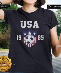 Alt Text: 1985 Official USA Soccer Team Ladies Tee featuring vintage design and team logo, perfect for soccer fans.