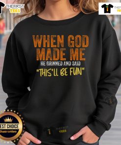 Funny sweatshirt with 'When God Made Me He Grinned And Said This'll Be Fun' text, perfect for casual wear and humor lovers.