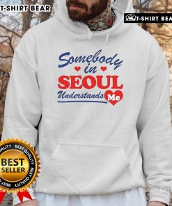 Person wearing a 'Pretty Somebody In Seoul Understands Me' hoodie, showcasing vibrant street style in Seoul.