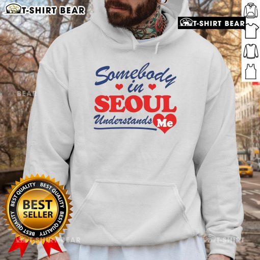 Person wearing a 'Pretty Somebody In Seoul Understands Me' hoodie, showcasing vibrant street style in Seoul.