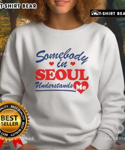 Stylish Pretty Somebody in Seoul Understands Me sweatshirt worn in a vibrant urban setting, showcasing trendy street fashion.