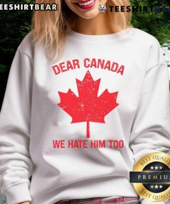 Cozy Canada sweatshirt with maple leaf design and 'We Hate Him Too' slogan, perfect for expressing Canadian pride.