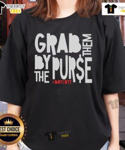 Women wearing 'Grab Them By The Purse' protest tees at a capitalism boycott rally, promoting social justice and equality.