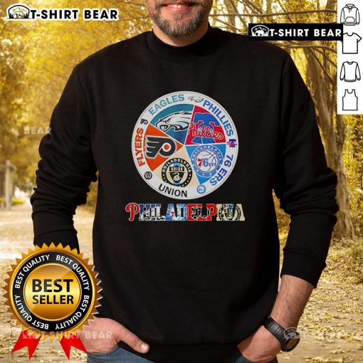 Cozy sweatshirt featuring top Philadelphia teams: Flyers, Eagles, Phillies, 76ers, and Union logos for sports fans.