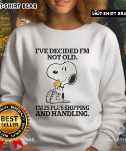 Alt Text: Snoopy and Woodstock sweatshirt with 'I'm not old, I'm 25 plus shipping and handling' graphic design.