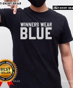 Top winners wearing blue T-shirts celebrate their achievements at an awards ceremony, showcasing pride and teamwork.