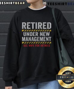 Funny retired husband wearing a retirement sweatshirt at his retirement party, celebrating a new chapter in life.