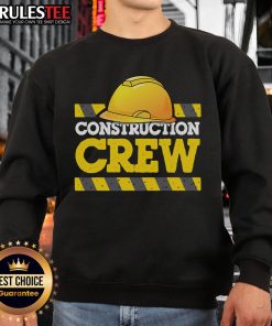 Awesome construction crew wearing hard hats and sweatshirts on a job site, showcasing teamwork and safety.