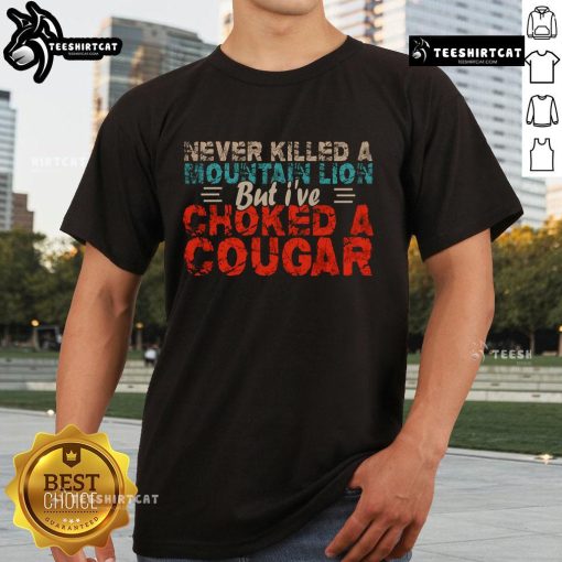 Funny Never Killed A Mountain Lion But I've Choked A Cougar T-Shirt design featuring playful graphics and bold text.