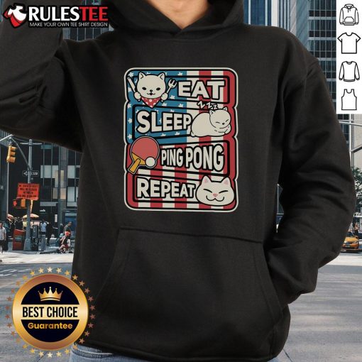 Alt Text: Adorable cat wearing a 'Eat Sleep Ping Pong Repeat' patriotic hoodie, embodying fun and playful table tennis spirit.