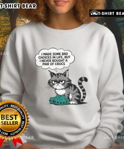 Adorable cat wearing a sweatshirt that says 'I made some bad choices in life, but I never bought a pair of Crocs.'