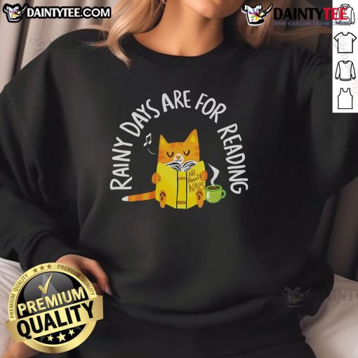 Alt Text: Cute cat in a cozy reading nook wearing a Rainy Days Are For Reading sweatshirt, perfect for cat lovers.