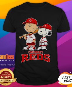 Cute Cincinnati Reds Charlie Brown and Snoopy baseball cartoon fan t-shirt featuring playful graphics and vibrant colors.