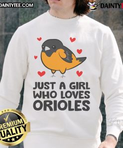 Cute girl wearing an Orioles sweatshirt, showcasing her love for the team in a trendy and stylish look.