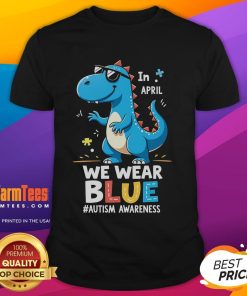 Alt Text: Cute T-Rex dinosaur wearing sunglasses on an Autism Awareness T-shirt, promoting positivity and inclusion.