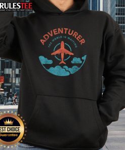 Funny adventurer wearing a 'The World Is Waiting For Travelers' hoodie next to a plane, ready for travel adventures.