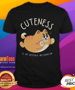 Funny Cat Cuteness Is My Defense Mechanism T-Shirt featuring a playful cat design, perfect for cat lovers and humor enthusiasts.