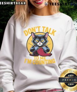 Funny cat in a knitting-themed sweatshirt saying 'Don't talk to me, I'm counting' for knitting lovers.