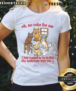 Funny cats in a tiny bathroom, playfully ignoring Coke, wearing humorous expressions on a ladies' tee shirt.