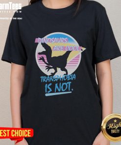 Funny dinosaurs graphic on a women's tee with text: 'Dinosaurs Are Cool, Transphobia Is Not' promoting inclusivity.