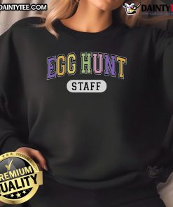Staff wearing Funny Egg Hunt varsity Easter event sweatshirts celebrate at an outdoor spring gathering.