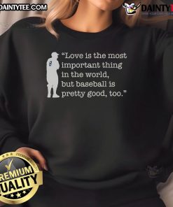 Alt Text: Yogi Berra sweatshirt featuring the quote Love is important, but baseball is pretty good too, celebrating humor and sports.