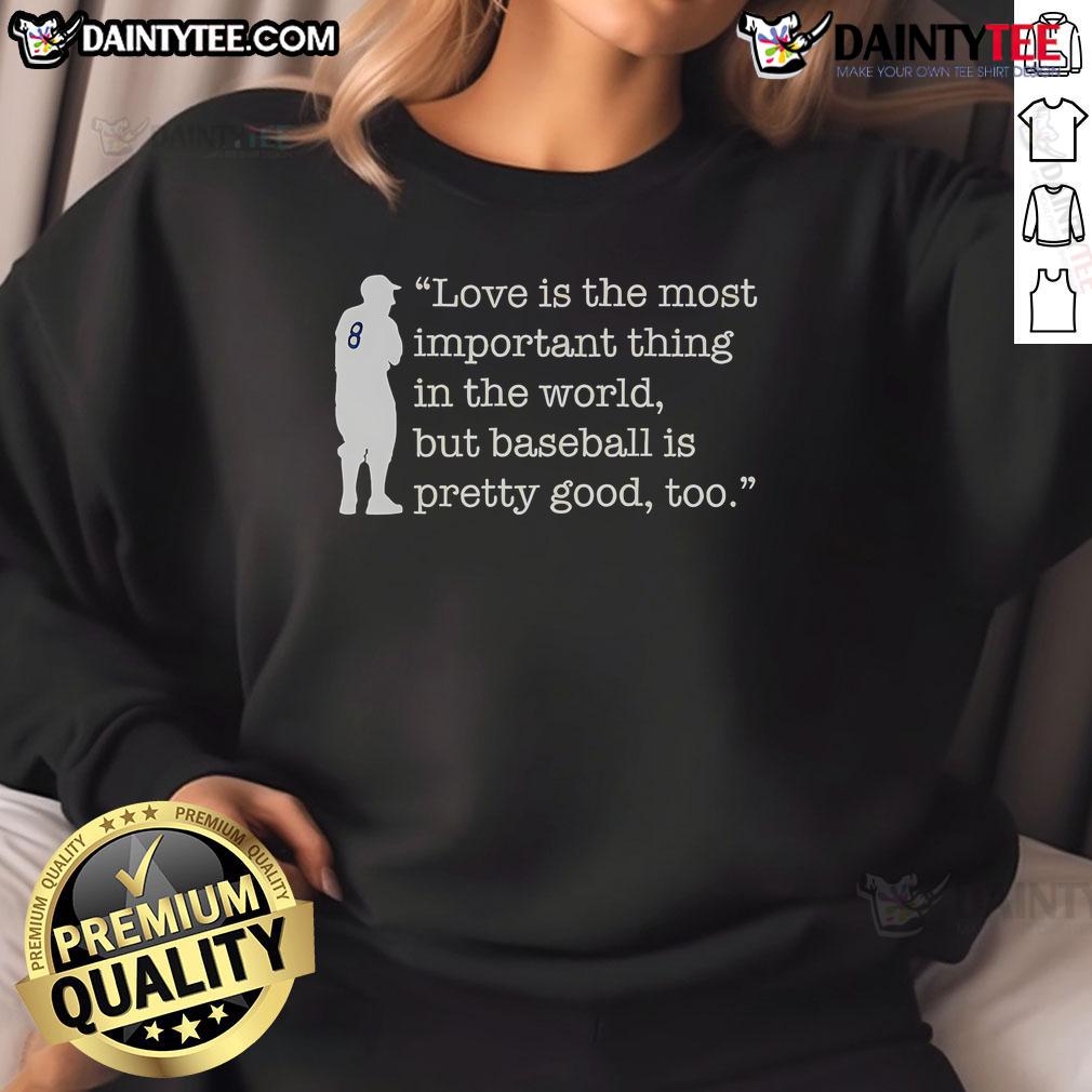 Funny Love Is The Most Important Thing In The World But Baseball Is Pretty Good Too Yogi Berra Sweatshirt Alt Text: Yogi Berra sweatshirt featuring the quote Love is important, but baseball is pretty good too, celebrating humor and sports.
