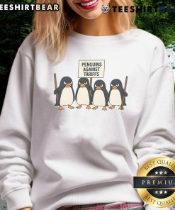 Funny penguins protesting against tariffs on a colorful sweatshirt design featuring cartoon penguins.