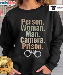 Funny person wearing a prison sweatshirt poses for the camera with a man, showcasing a playful and humorous vibe.