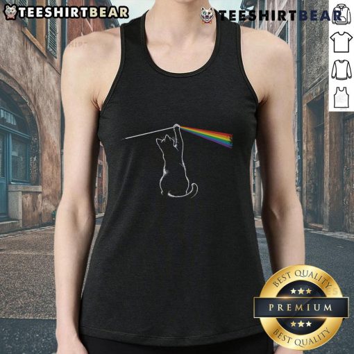 Funny cat wearing a tank top, playfully interacting with light, showcasing adorable antics and playful spirit.