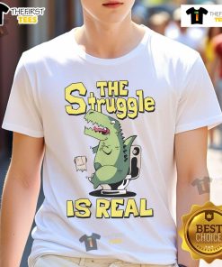 Alt Text: Funny The Struggle Is Real Dinosaur Toilet T-Shirt featuring a cartoon dinosaur on a toilet, perfect for humor lovers.