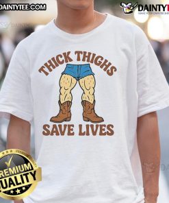 Alt Text: Funny Thick Thighs Save Lives Cowboy T-Shirt featuring a humorous graphic design and vibrant colors for casual wear.