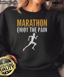 Runner wearing 'Enjoy The Pain' sweatshirt at a half marathon, showcasing determination and passion for marathon running.