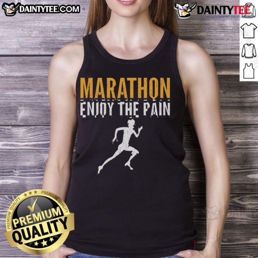 Runner in a tank top that says 'Enjoy the Pain' during a half marathon, showcasing marathon spirit and determination.