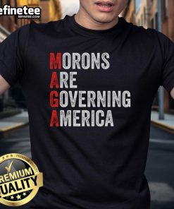 Alt Text: Good Morons Are Governing America Anti Trump Political T-Shirt design featuring bold text and graphic elements.