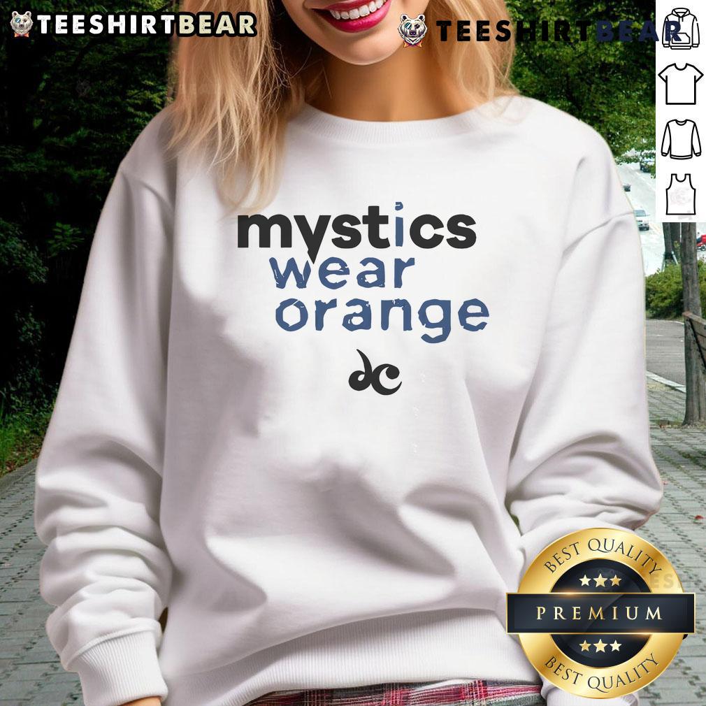 Good Mystics Wear Orange Sweatshirt Person wearing a vibrant orange sweatshirt with 'Good Mystics' printed, showcasing a trendy and cozy style.
