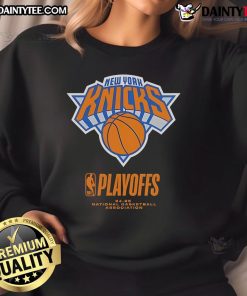 NY Knicks fanatic wearing an Alley Oop sweatshirt, celebrating the 2025 NBA Playoffs with enthusiasm and team spirit.
