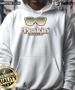 Person wearing a Good Peakin with Don Biz hoodie, showcasing stylish streetwear in an urban setting.