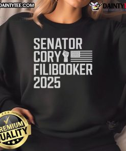Senator Cory Booker wearing a 'Cory Filibooker' sweatshirt, promoting New Jersey pride and activism.